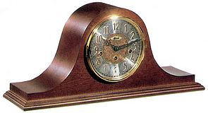 Hermle 21134-N90340 Cherry Keywound Chiming Mantel Clock Keywound Chiming mantel clock. Traditionally styled tambour case with an elegant cherry finish. The dial features a diamond turned chapter ring and a embossed center. The hands are metal serpentine...