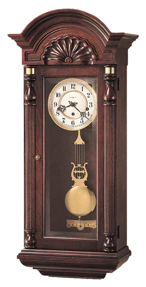 Howard Miller 612-221 Jennison Keywound Wall Clock An individually carved, scalloped shell on the pediment is designed similar to a John Goddard original.   Highly polished Viennese dial. A polished brass lyre pendulum swings by a beat plate....