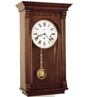 Howard Miller 613-229 Alcott Keywound Wall Clock An impressive pediment features a sculptured cove and enlarged dentil molding.  Off-white Roman numeral dial. Finished in Windsor Cherry on select hardwoods.  German Key-wound, Westminster chime...